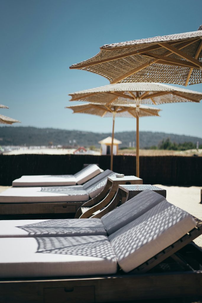 white outdoor lounges with umbrellas